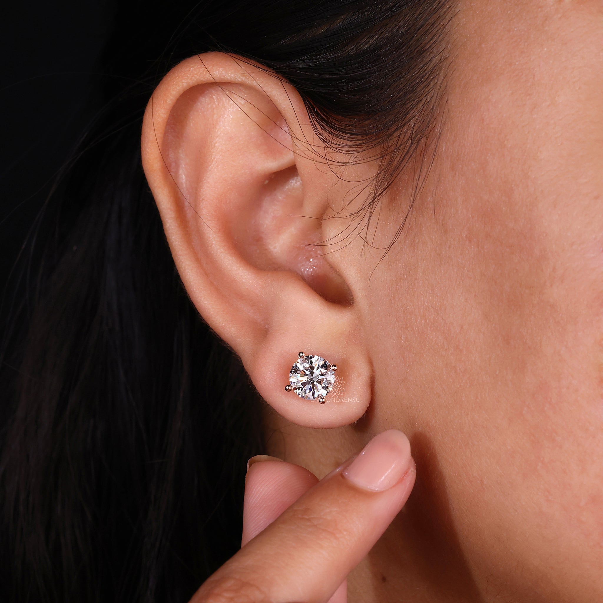 Large round diamond earrings in rose gold.