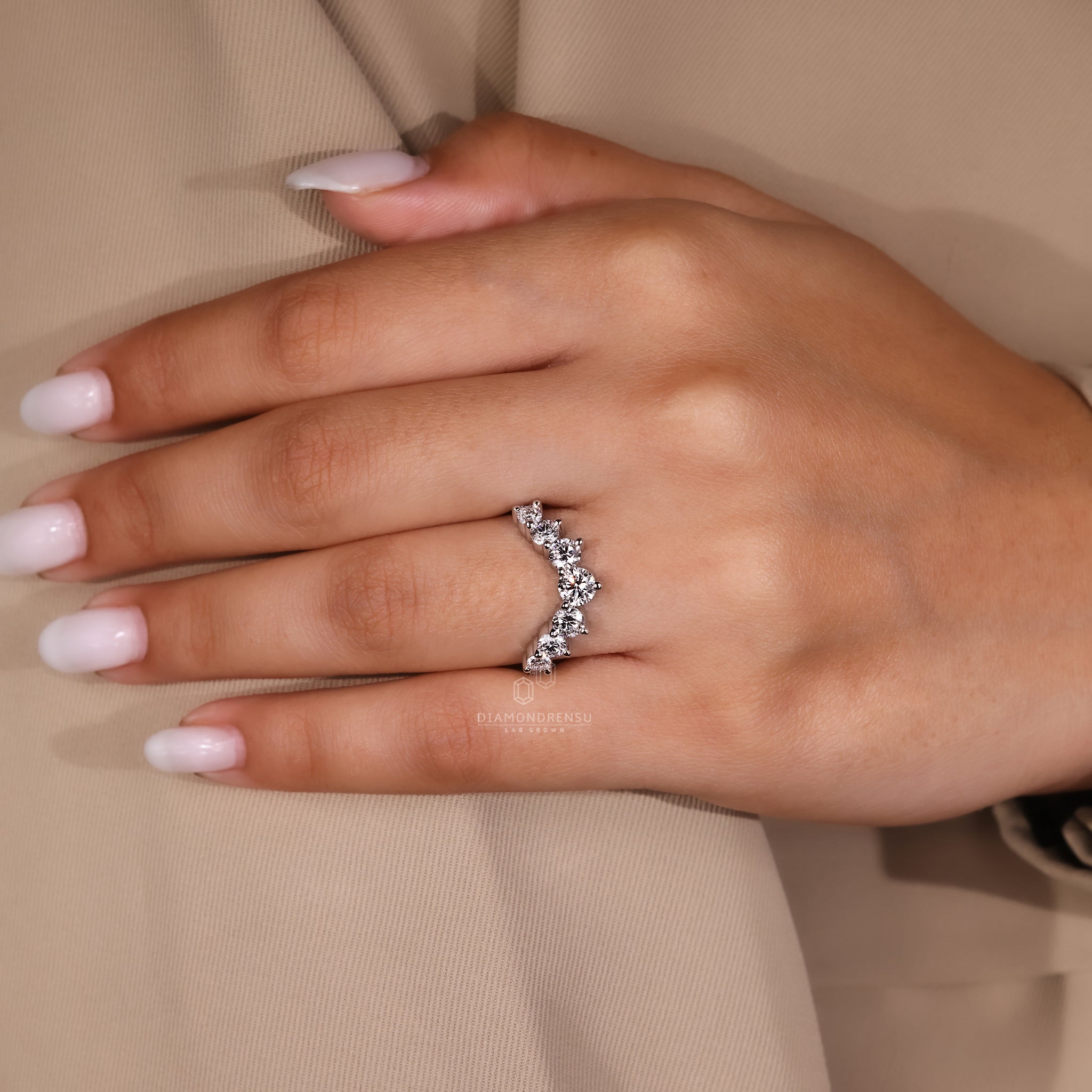 Custom diamond band featuring a U shaped curve and round stones.