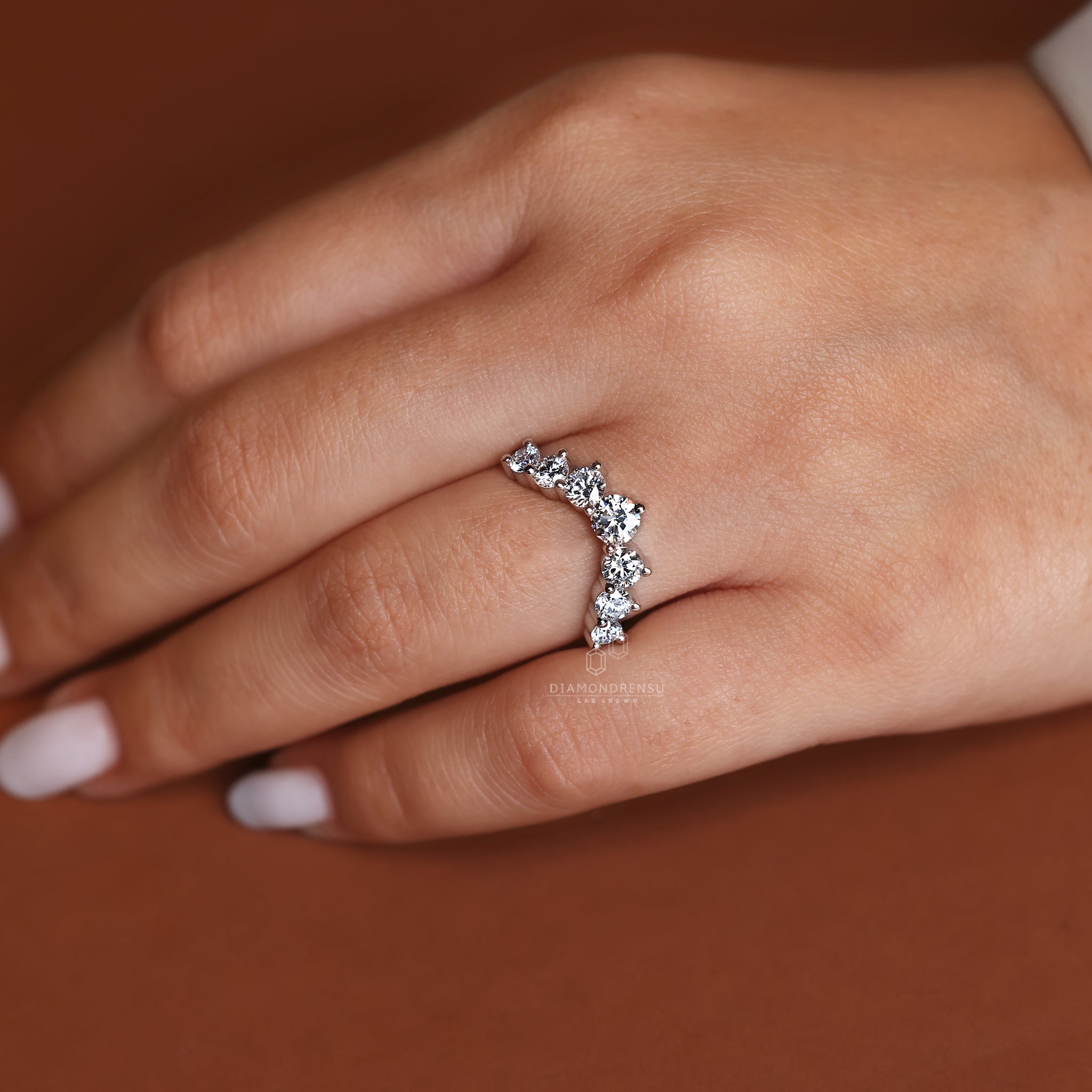 White gold wedding band featuring lab grown round cut diamonds.