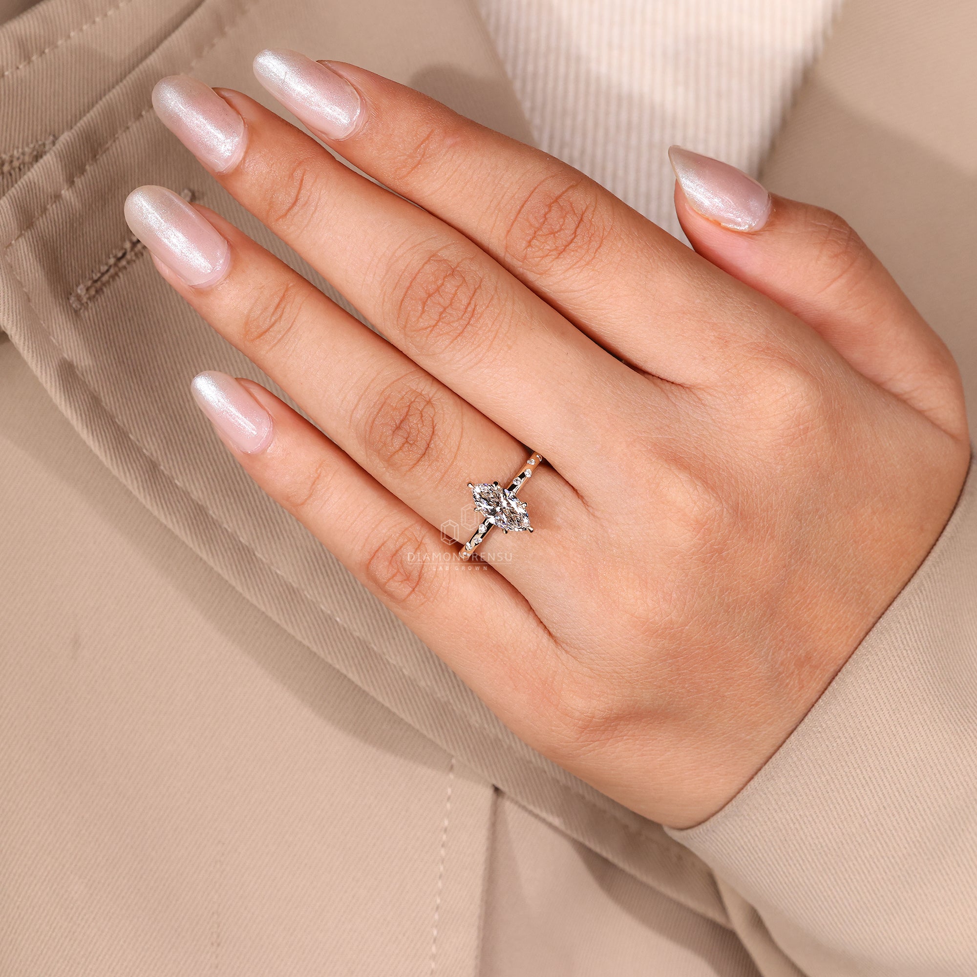 Yellow gold ring with marquise center and flush pave.
