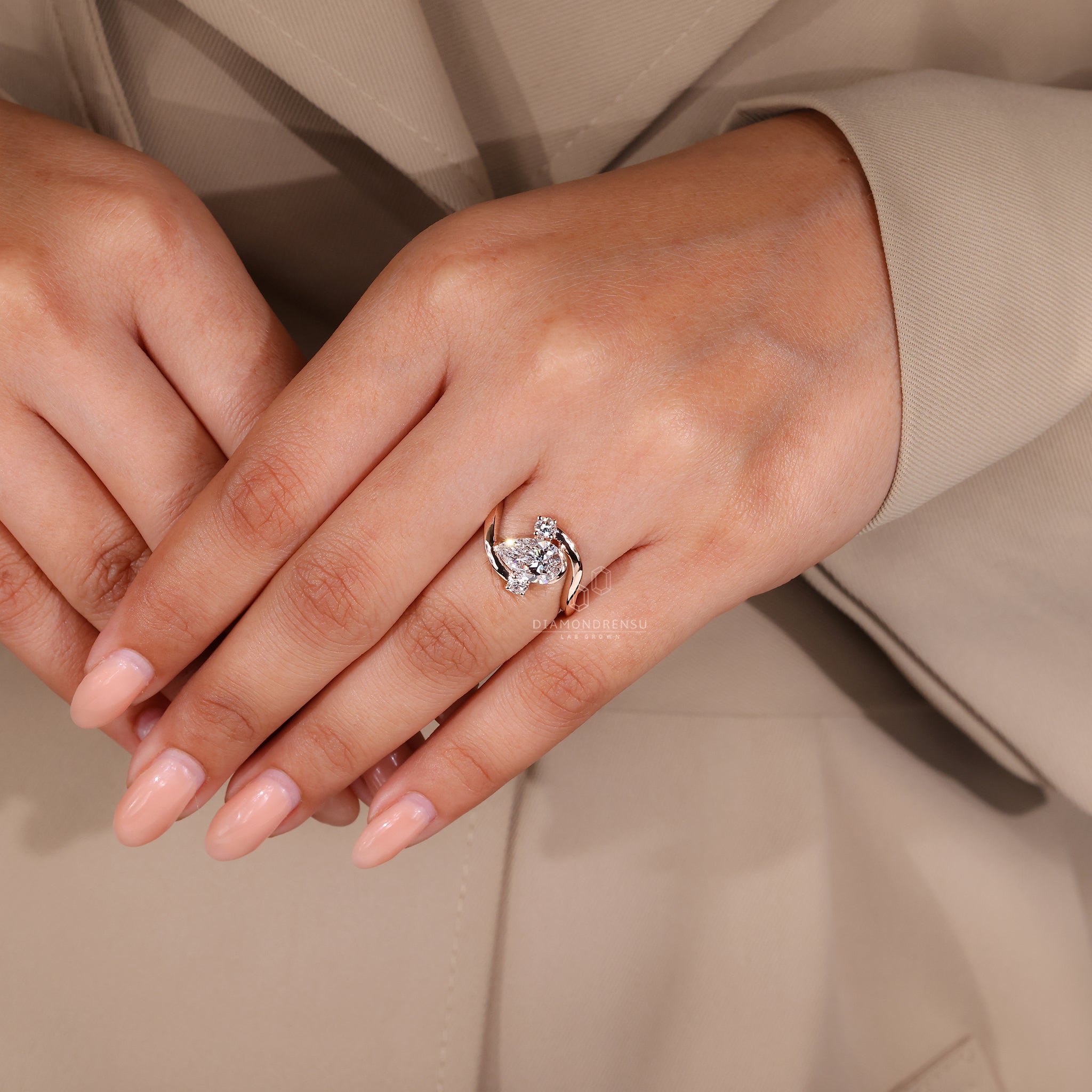 Unique ring featuring pear cut and round diamonds.
