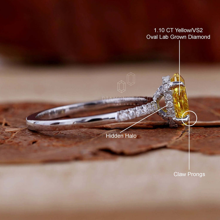 Pave ring featuring an oval yellow diamond in a claw prong setting for a modern engagement ring for women.
