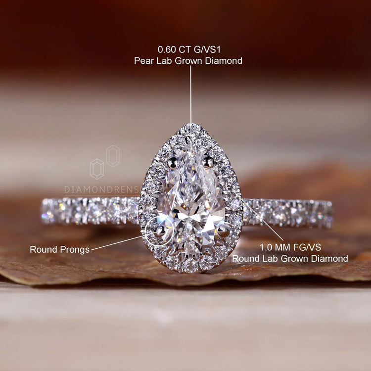 Halo ring ring featuring a pear diamond design and pave setting for a luxurious diamondrensu UK ring.
