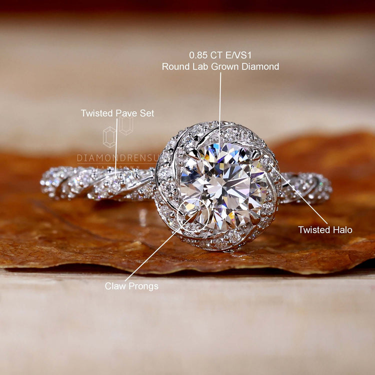 Contemporary twisted halo engagement ring with charm.