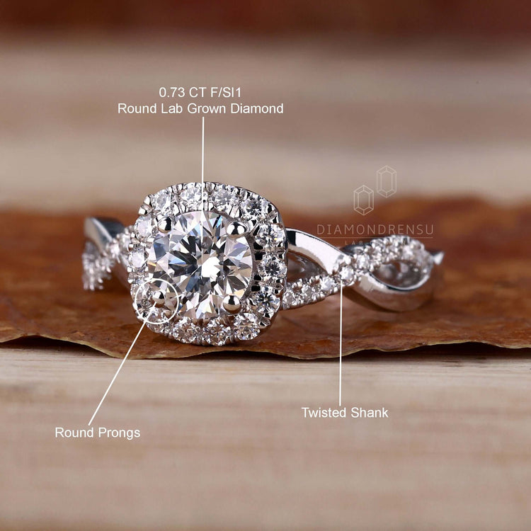 Halo ring with pave diamonds in a 4 prong round diamond engagement ring design for added sparkle.
