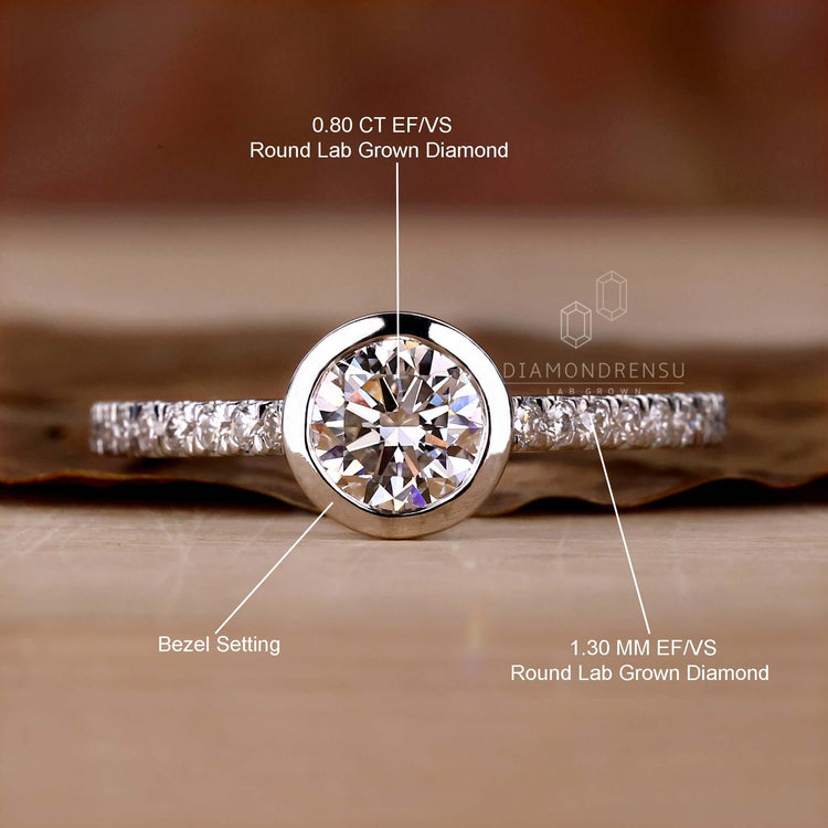 White gold engagement ring with bezel set diamond, perfect for a classic yet modern touch in UK engagement rings.
