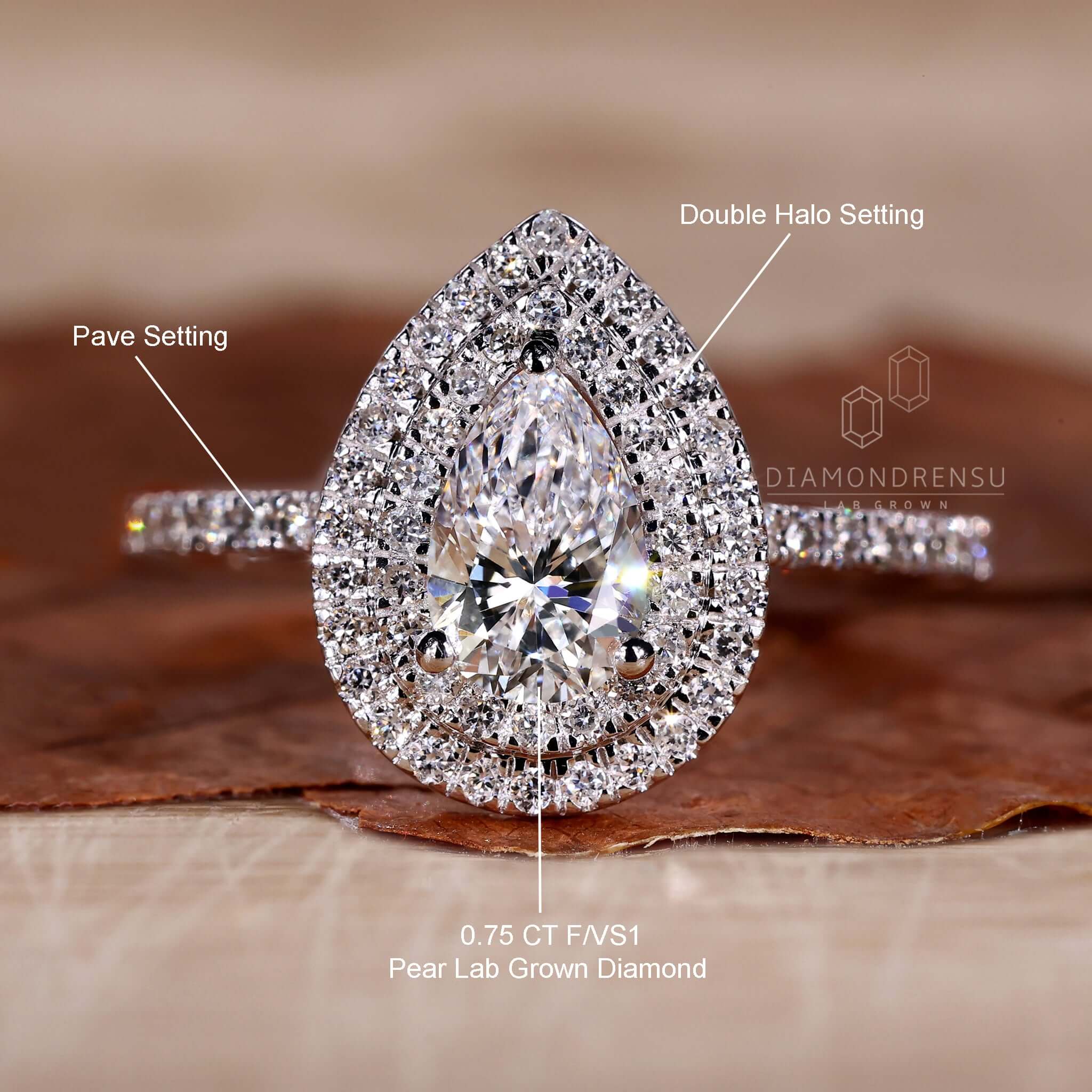 White gold ring with a pear shape diamond and pave ring setting for classic charm.
