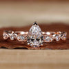 Engagement pear shaped ring with a classic claw prong engagement ring setting and milgrain details.