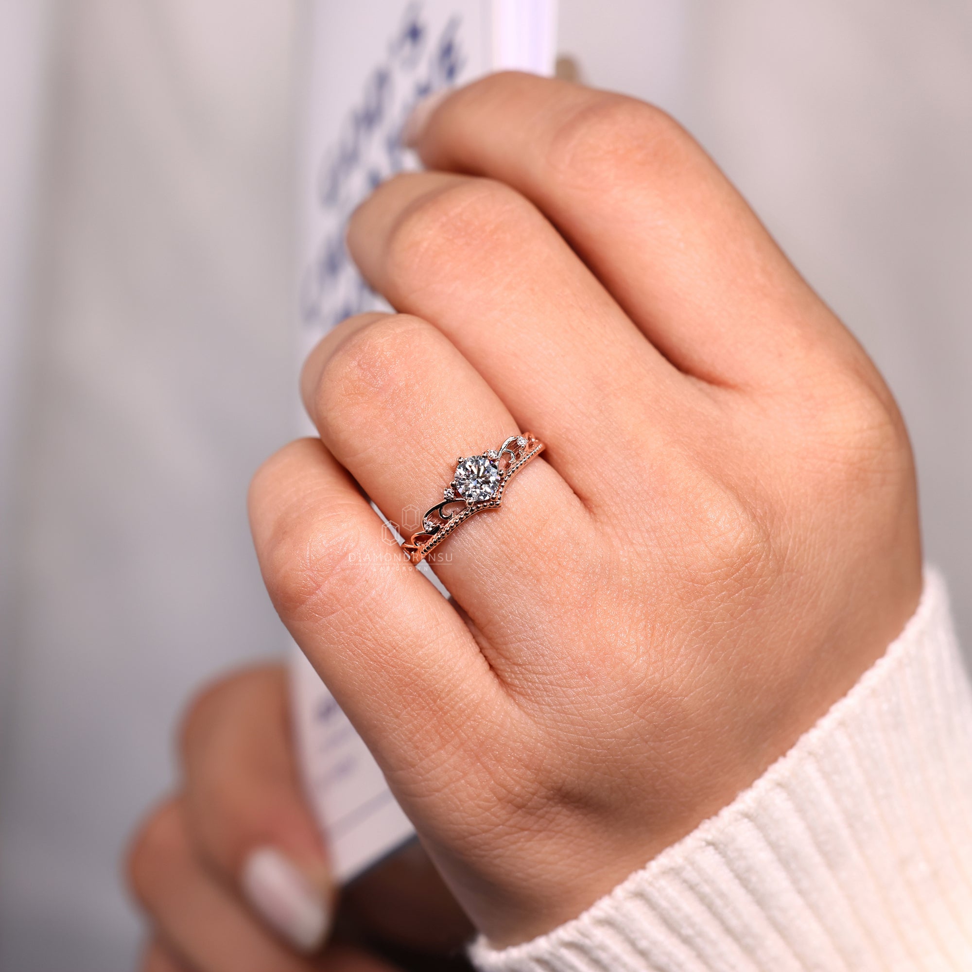 Round diamond ring featuring a milgrain setting.

