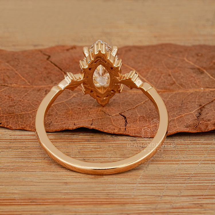 Handmade marquise diamond ring with side stones and prongs.