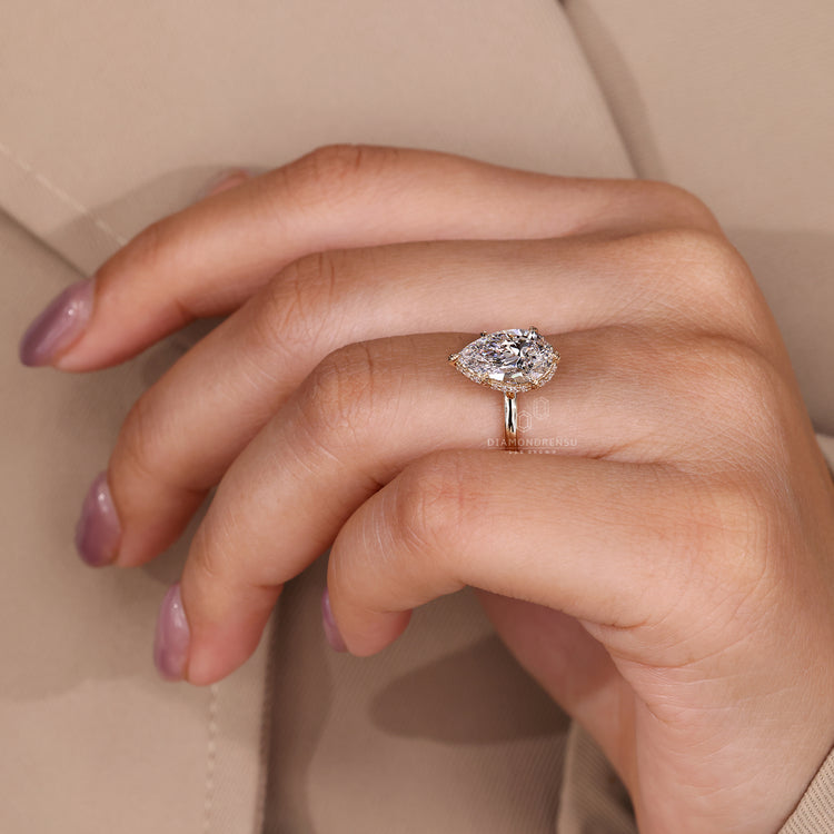IGI certified pear diamond ring with side halo band.