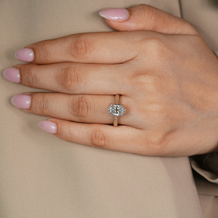 Handmade oval diamond ring with hidden bridge accent.