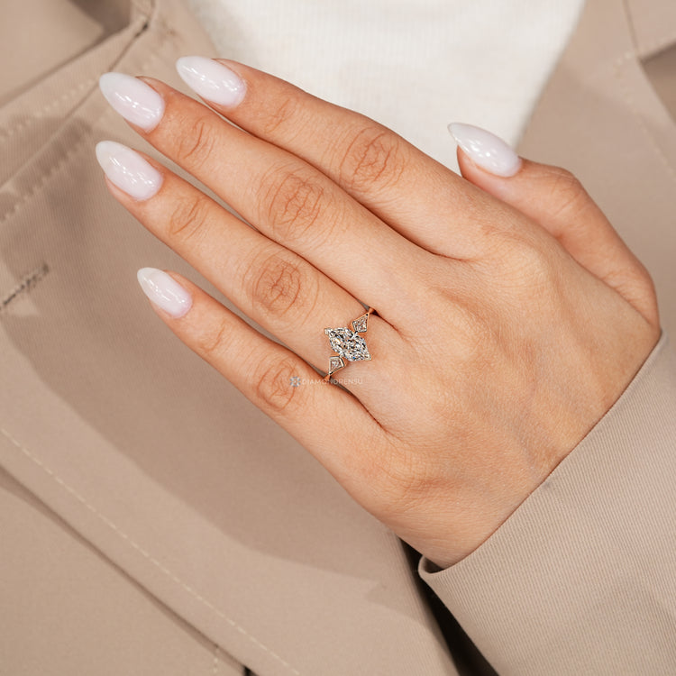 Three stone Dutch marquise ring with kite side stone.