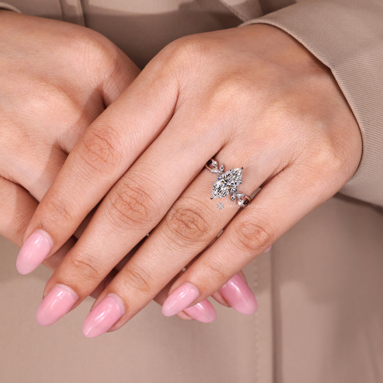 Handmade marquise cut ring with round side stones.