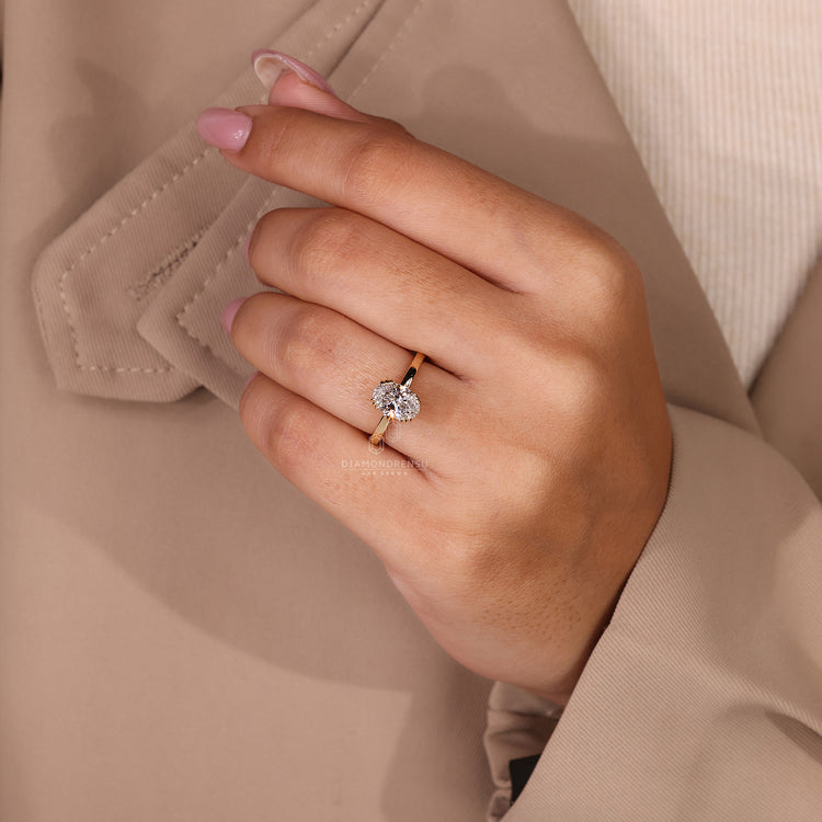 Handmade oval diamond ring with solitaire style and prongs.