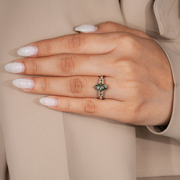 Green centre diamond ring with five claw prong setting.