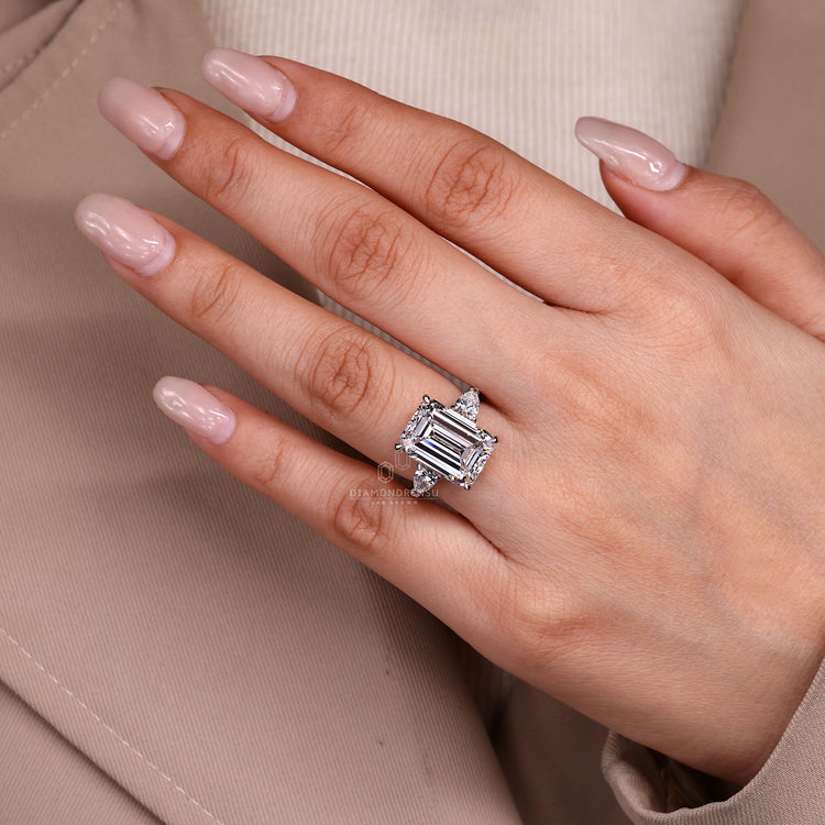 Lab grown emerald engagement ring with pear side stones.