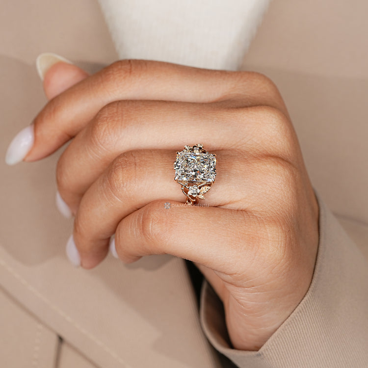 Radiant diamond ring with twisted shank and side stones.