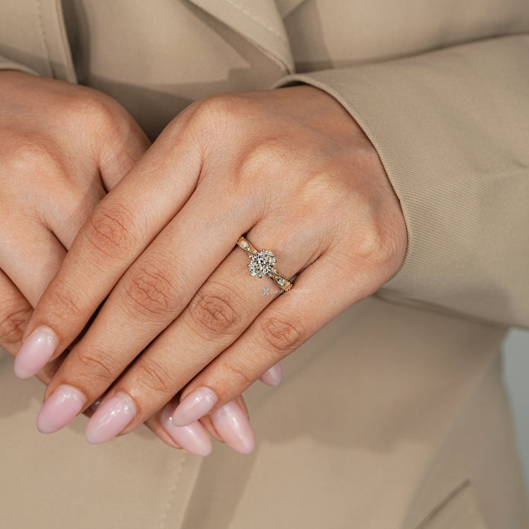 Art Deco oval engagement ring with four claw prongs.