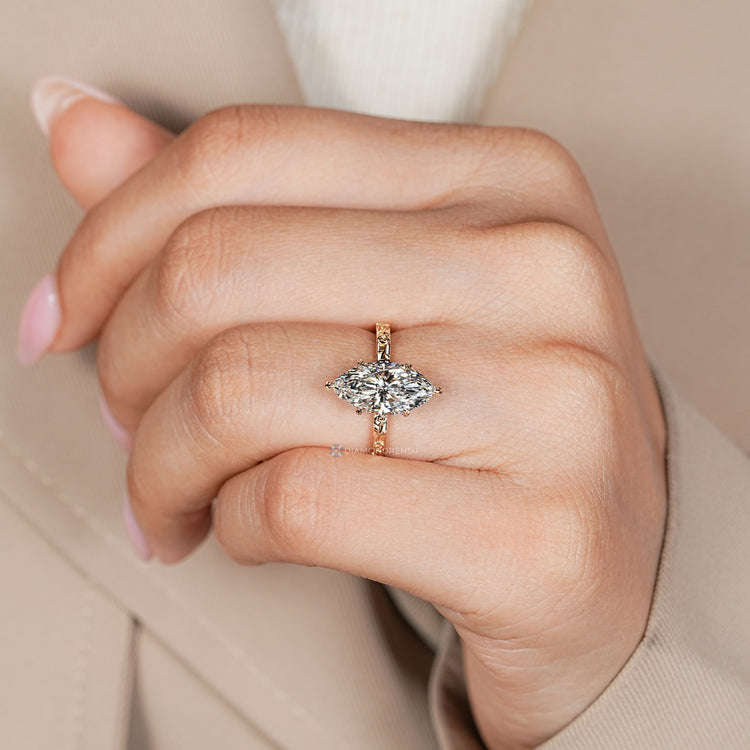 Nature inspired marquise engagement ring with six leaf prongs.