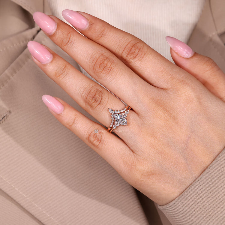 Marquise ring with v shaped band and side stones.