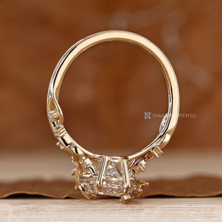 Six leaf prong setting marquise ring with side stones.