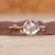 Round cut diamond ring in yellow gold.