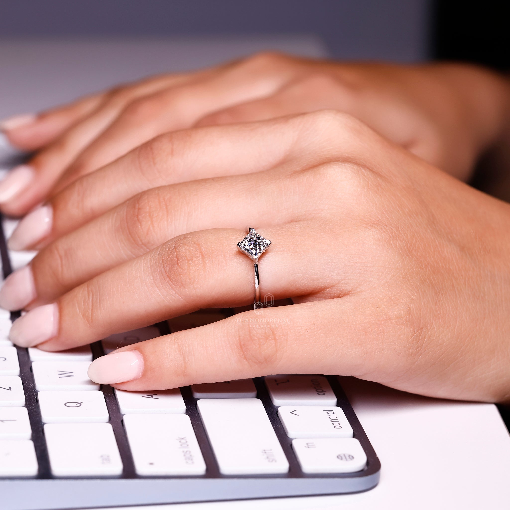 Compass prong ring with princess cut diamond.