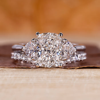 Cushion cut ring with wedding band in a custom white gold bridal set.

