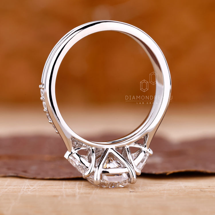 Cathedral setting ring with tapered shank and trillion side stones.
