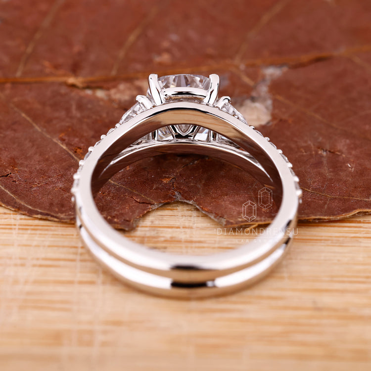 Bridal set featuring cushion cut engagement ring and round diamond wedding band.
