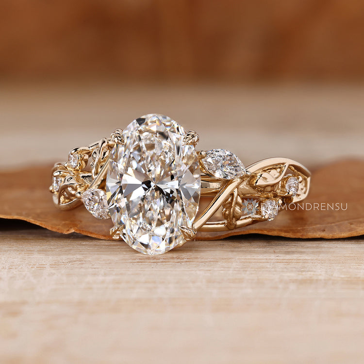 Oval engagement ring with marquise and round side stones.