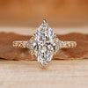 Marquise engagement ring with round side stone and muse setting.
