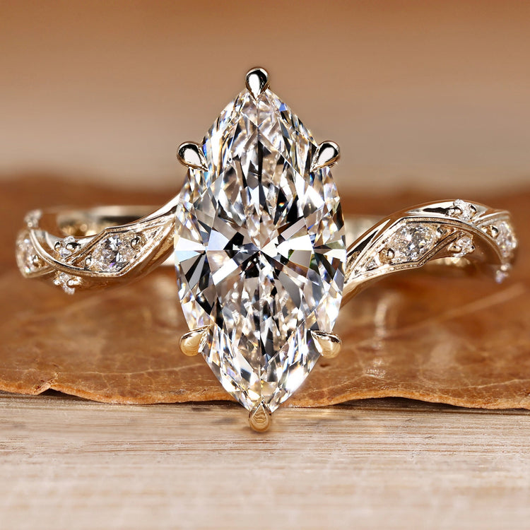 Marquise cut diamond ring with marquise and round side stones.
