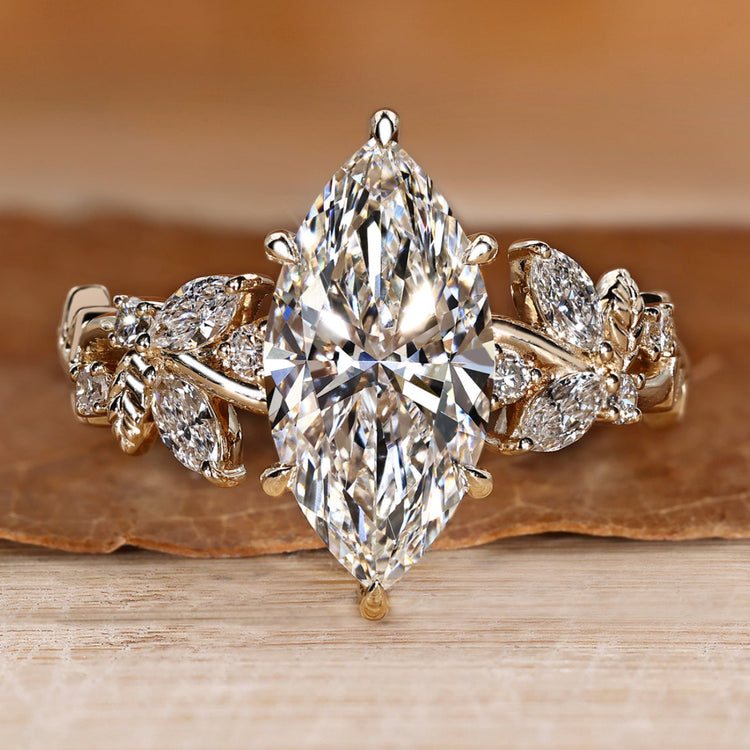 Marquise diamond ring with round side stones.