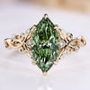 Marquise cut engagement ring with green centre diamond.