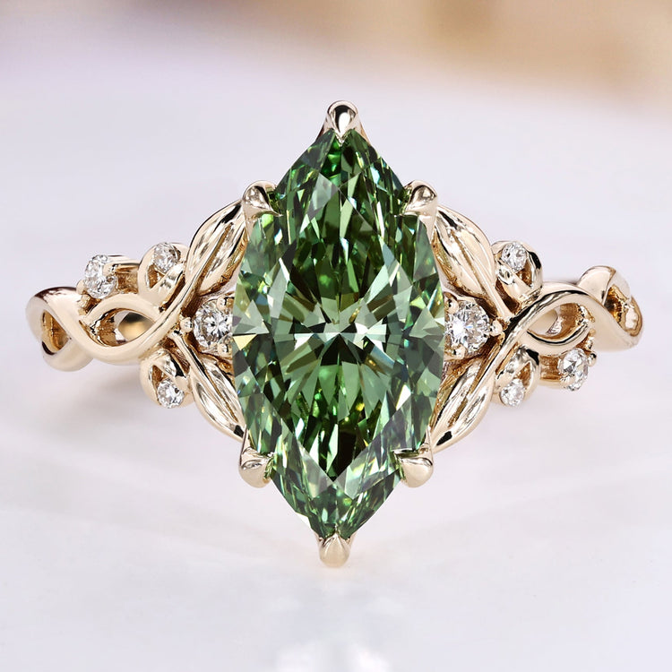Marquise cut engagement ring with green centre diamond.