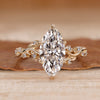 Marquise cut engagement ring with round side stones.