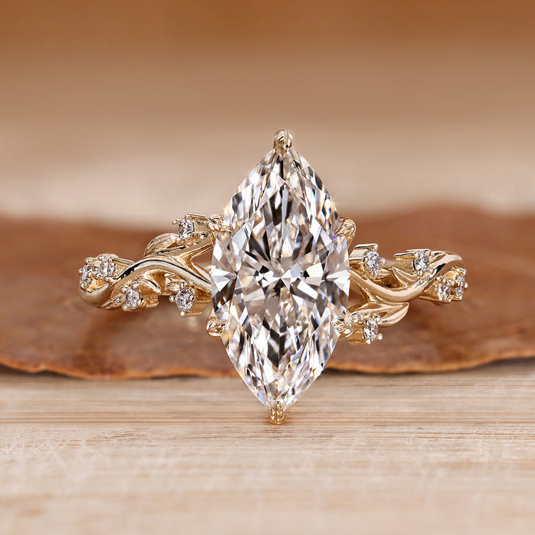 Marquise cut engagement ring with round side stones.
