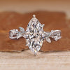 Marquise cut diamond ring with round side stones.