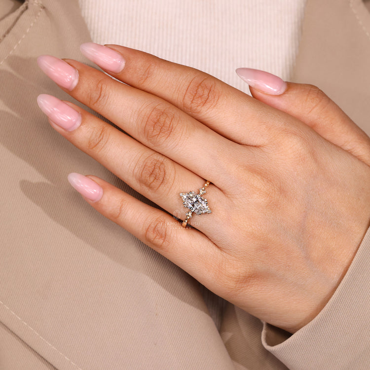 Marquise cut engagement ring with round side stone setting.