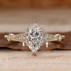 Marquise cut engagement ring with round side stones.
