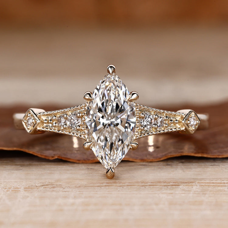 Marquise cut engagement ring with round side stones.