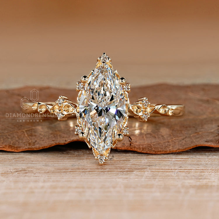 Marquise cut lab grown diamond ring with round side stones.