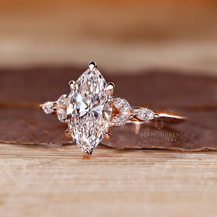 Marquise diamond ring with tulip setting and sharp band.
