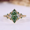 Marquise cut diamond ring with green centre diamond.