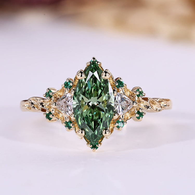 Marquise cut diamond ring with green centre diamond.