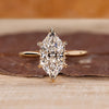 Marquise cut diamond ring with hidden halo and tapered band.