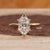 Marquise cut diamond ring with hidden halo and tapered band.