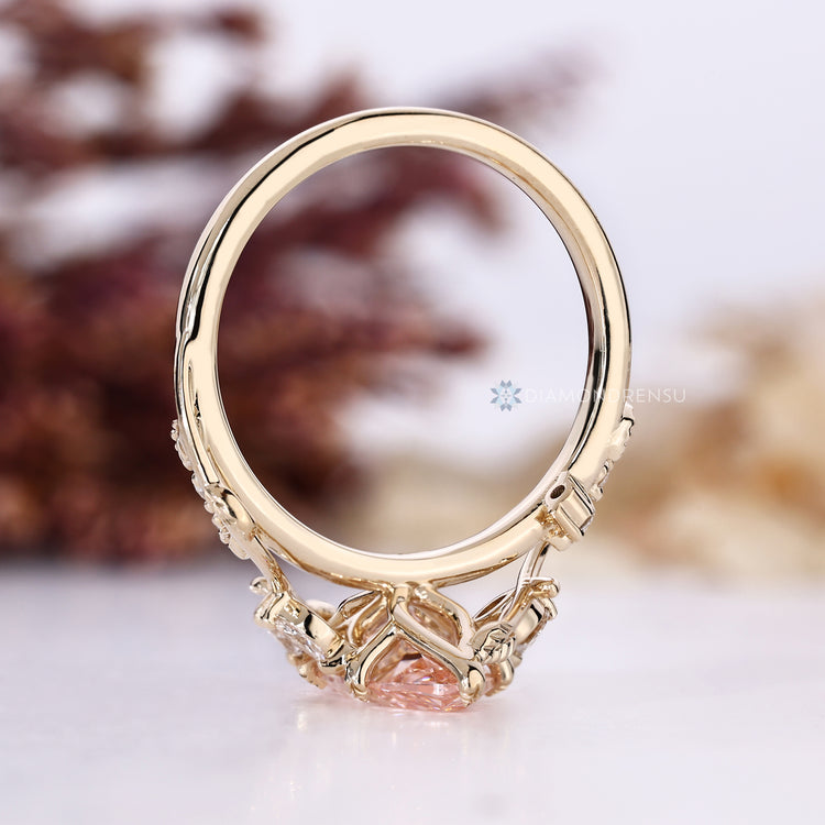 Pink centre marquise ring with round side stones.